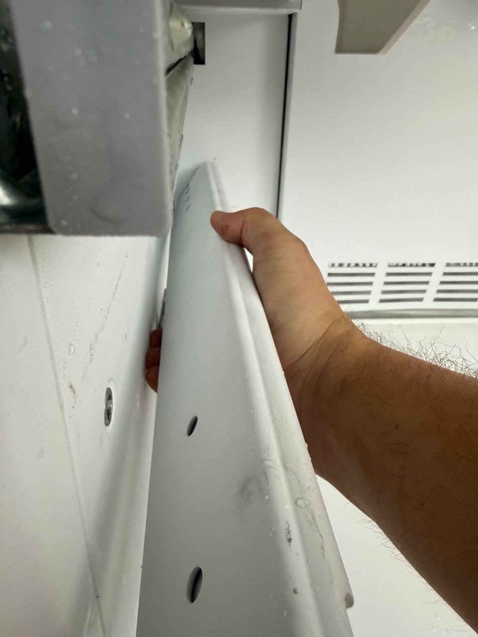 Technician servicing the interior panel of a refrigeration unit