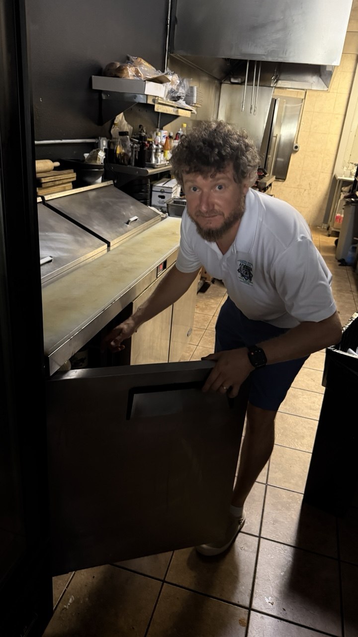 Technician performing commercial appliance repair in Naples